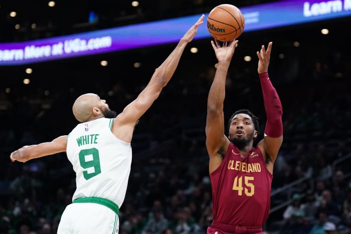 Dec 14, 2023; Boston, Massachusetts, USA; Cleveland Cavaliers guard Donovan Mitchell (45) shoots against Boston Celtics guard Derrick White (9) in the first quarter at TD Garden.